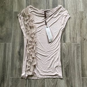 Beautiful cap sleeved 100% rayon blouse with ruffled details on one side.